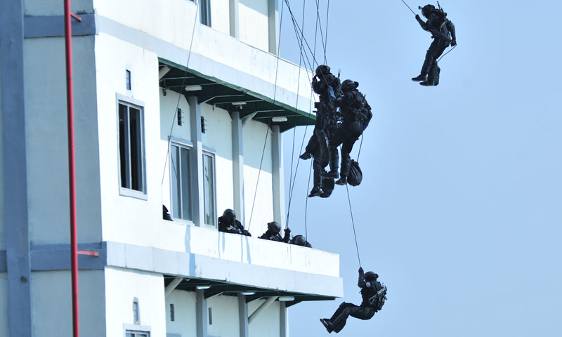 Members of an elite Indonesian counterterrorism group repel down the front of a building during a multinational counterterrorism exercise in Sentul, Indonesia. NPS’ Center for Civil-Military Relations played a lead role in designing the exercise, helping develop regional capacity through a multinational approach to combating terrorism. (Photo courtesy NPS Center for Civil-Military Relations)