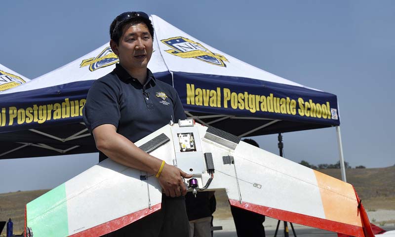 Dr. Timothy Chung, an Assistant Professor with the NPS Department of Systems Engineering, describes the on board intelligence of the Unicorn unmanned aerial vehicle (UAV) during a Joint Interagency Field Exploration (JIFX) event held by the Naval Postgraduate School, Aug. 5-8. Chung’s research team hopes to utilize the Unicorn, and its autonomous capabilities, to demonstrate how only a few ground operators can command up to 50 aircraft simultaneously.