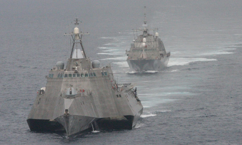 The first of the littoral combat class (LCS) ships, USS Freedom (LCS 1), rear, and USS Independence (LCS 2), maneuver together during an exercise off the coast of Southern California. The Naval Postgraduate School’s new Littoral Operations Center, will help synthesize and advance the university’s research into the new surface combatant designed to operate in the near-shore environment.
