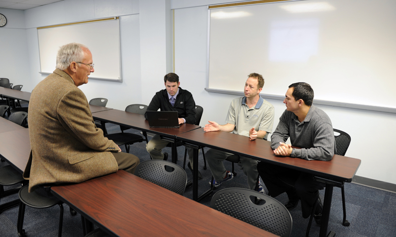 Students in the Defense Budget and Financial Management Policy class discuss with Professor Douglas Brook possible ways to reduce federal debt, a conversation sparked by a debt-reduction simulation the class worked through.