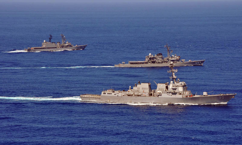 The guided-missile destroyer USS Chafee (DDG 90), front, and the Japan Maritime Self-Defense Force destroyers JS Yamayuki (DD-129) and JS Yamagiri (DD-152) conduct formation drills during a passing exercise.