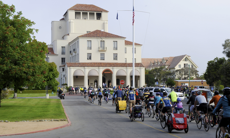 Nearly 200 cyclists from the Naval Postgraduate School (NPS) and local communities arrive at the flagpole on the NPS campus for a brief prayer and moment of silence during a Tribute Ride for the late Capt. Alan "Dex" Poindexter. The Cycling Club hosted the community ride to honor Poindexter, the late NPS Dean of Students and Executive Director of Programs.