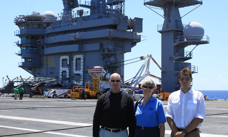 The MOVES Institute’s Dr. Michael McCauley, far left, stands beside Stephanie Everett of the Office of Naval Research, and Dr. Mathias Kolsch, also of MOVES, during their visit to the USS Eisenhower to test the iPARTS software in the fleet.