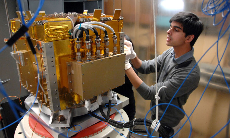 Space Systems Engineering student Vidur Kaushish performs final testing procedures on the Naval Postgraduate School designed and built CubeSat axillary payload platform. The launcher will send several CubeSats into Low Earth Orbit when it is launched in August of this year.