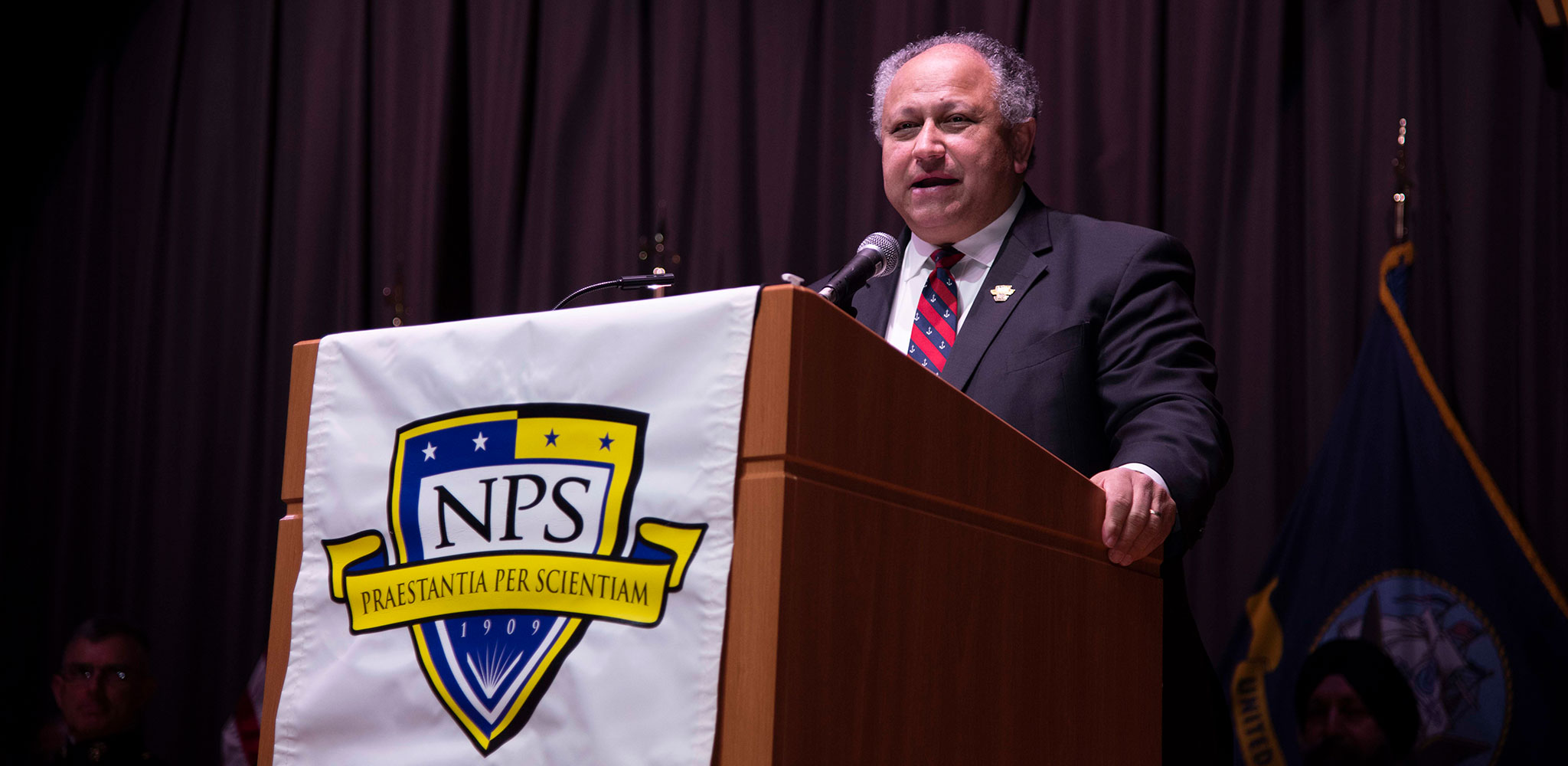 Secretary of the Navy Carlos Del Toro gives the commencement address during NPS Fall Quarter graduation.