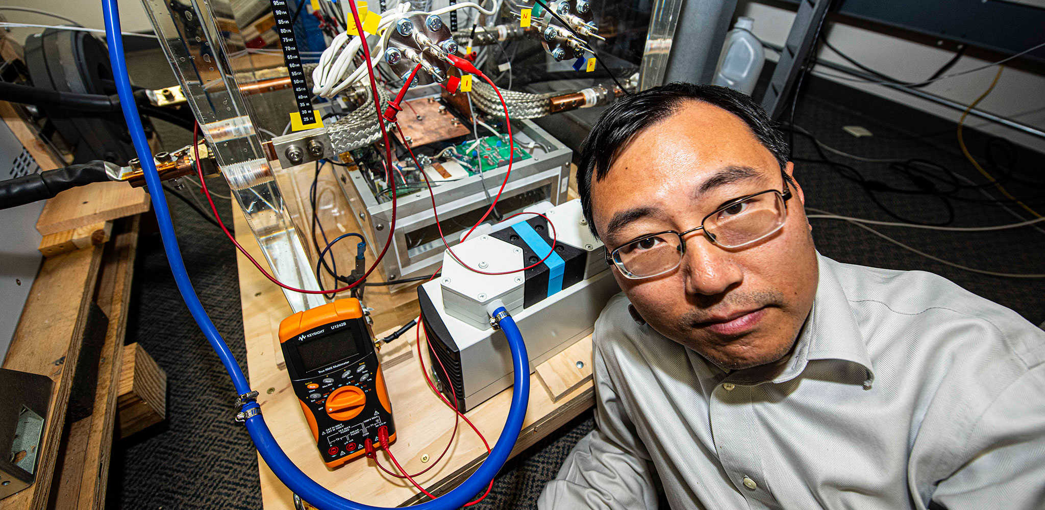 NPS Associate Professor Dr. Di Zhang in his lab testing a circuit breaker.