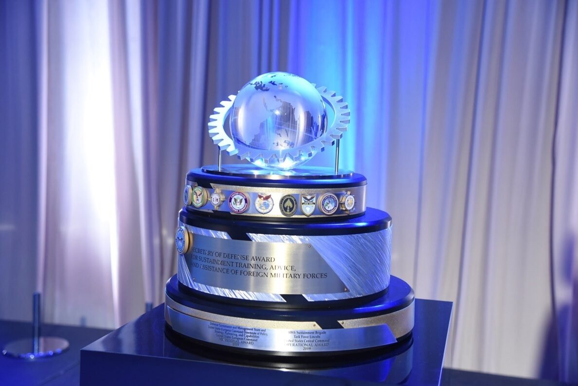 a picture of the SECRETARY OF DEFENSE MAINTENANC award with the silver globe on the top