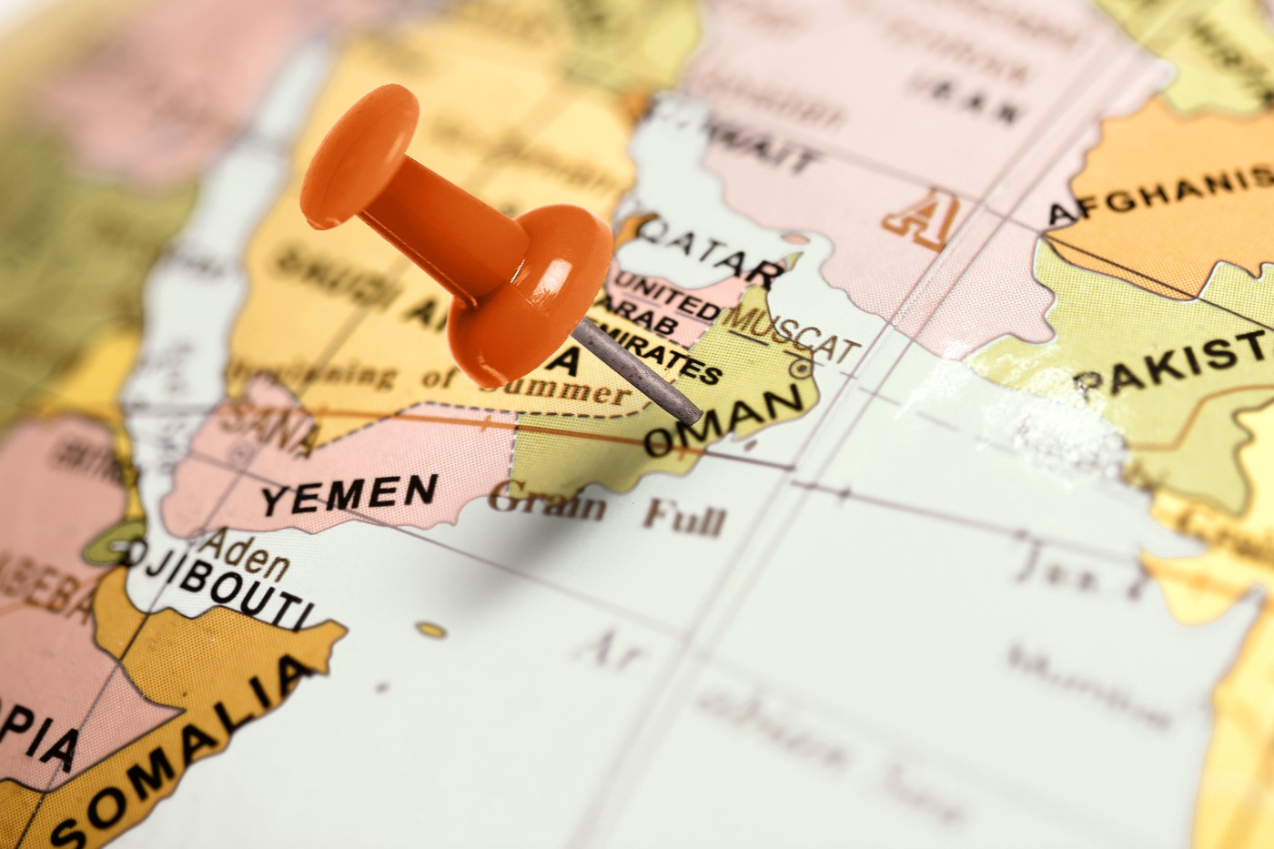 a picture of a map with a red pin placed on the country Oman