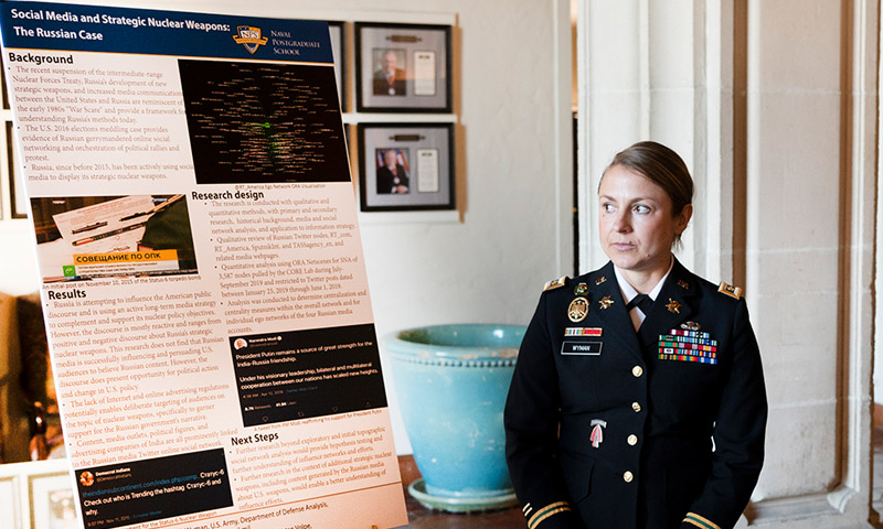 U.S. Army Maj. Trisha Wyman prepares to present during the annual Defense Analysis Research Week.